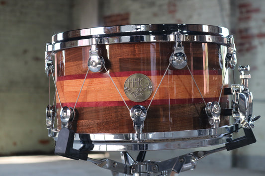 Segmented Bubinga, Purpleheart, and Walnut Snare Drum with high glass natural lacquer and welch tuning system