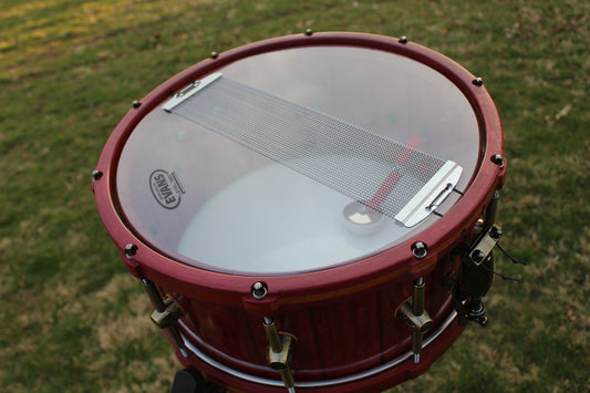 Purpleheart and bubinga stave snare drum with matching wood hoops and antique bronze hardware